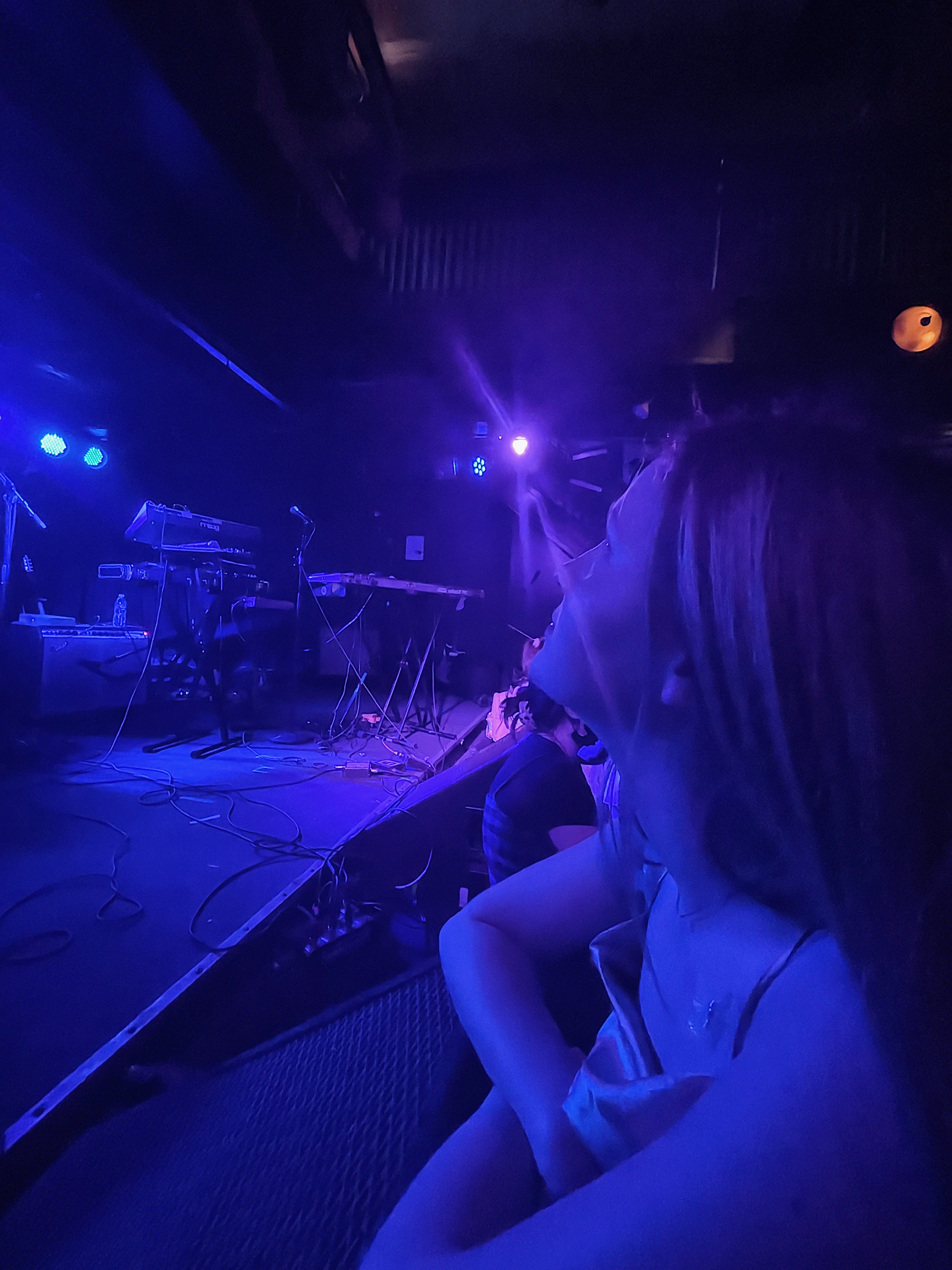 elaina in blue ligths at a concert