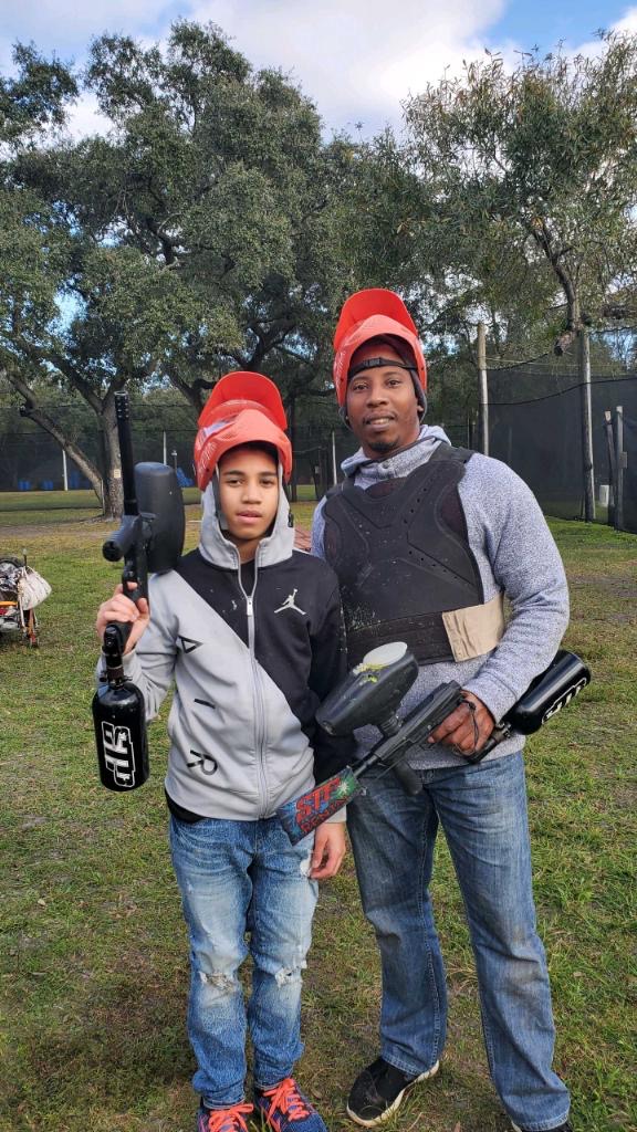 this is a photo of my brother and dad paintballing