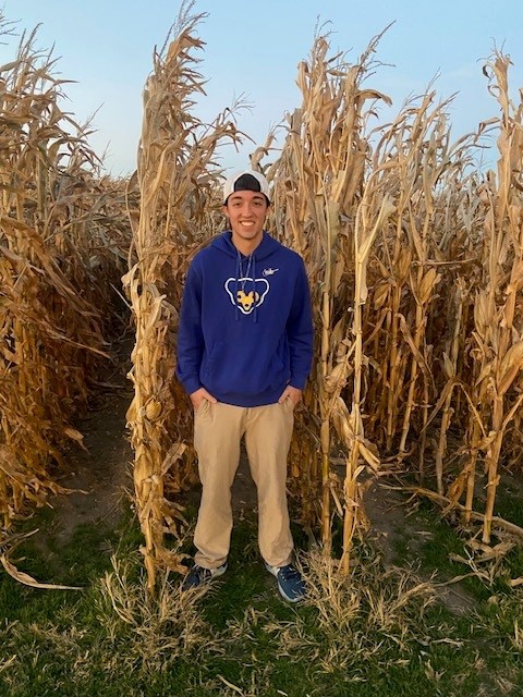 photo of Sean Haywood coming out of the corn