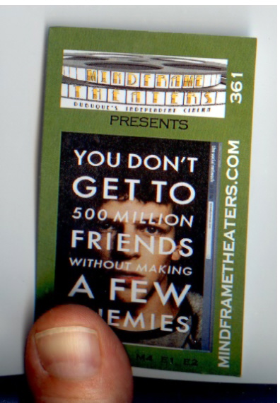 Hitchcock holding the ticket stub for The Social Network